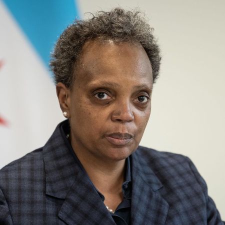 Lori Lightfoot in a black coat poses for a picture.
